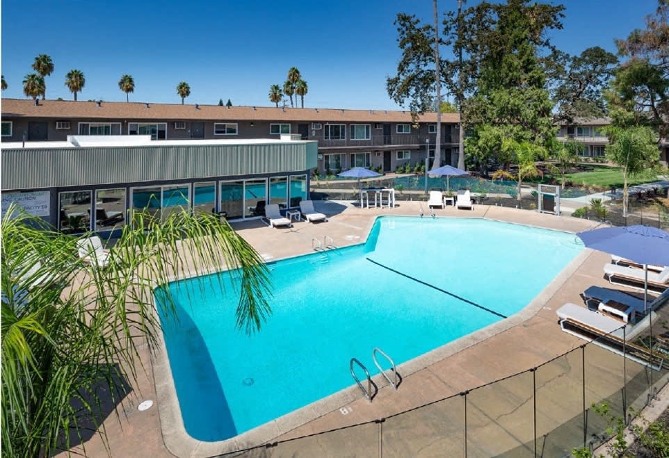 Sparkling Large Pool with Lounge Chairs and Umbrellas at Aspire Sacramento Apartments, California, 95825