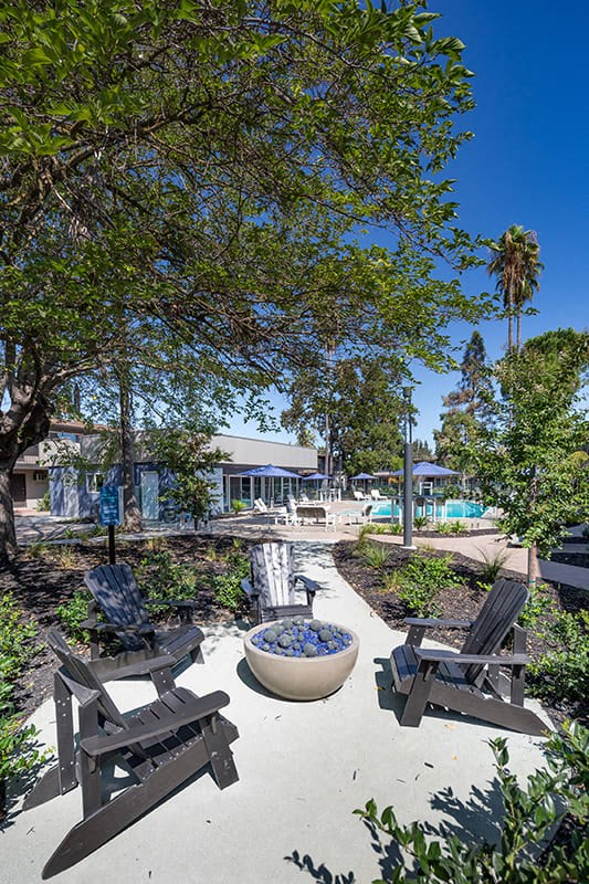 Fire pit with seating by pool at Aspire Sacramento Apartments, Sacramento, California
