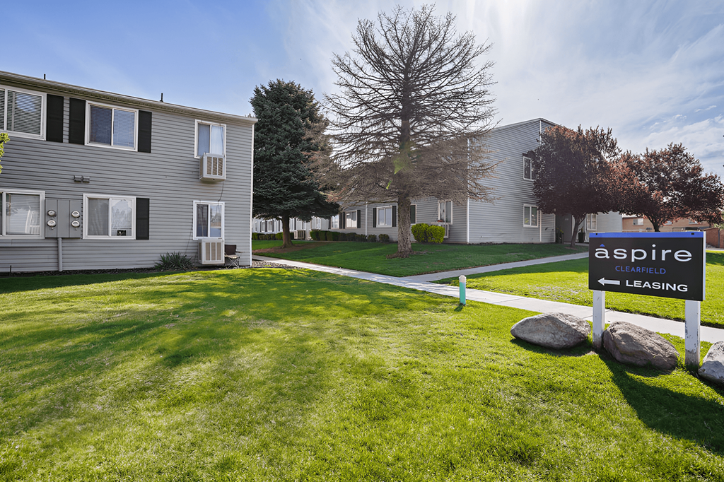 an aspire leasing sign in front of a house