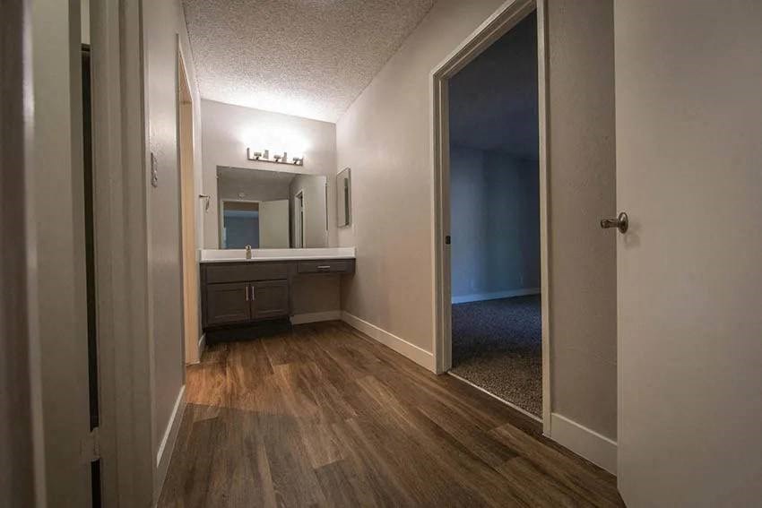 a bathroom with a sink and a large mirror at Aspire Upland Apartments, Upland, California