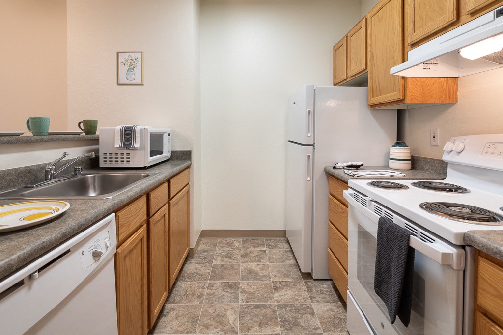 a kitchen with a stove refrigerator and sink