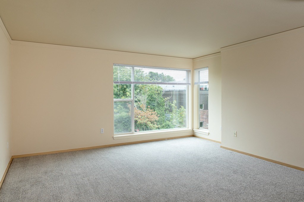 an empty living room with a large window