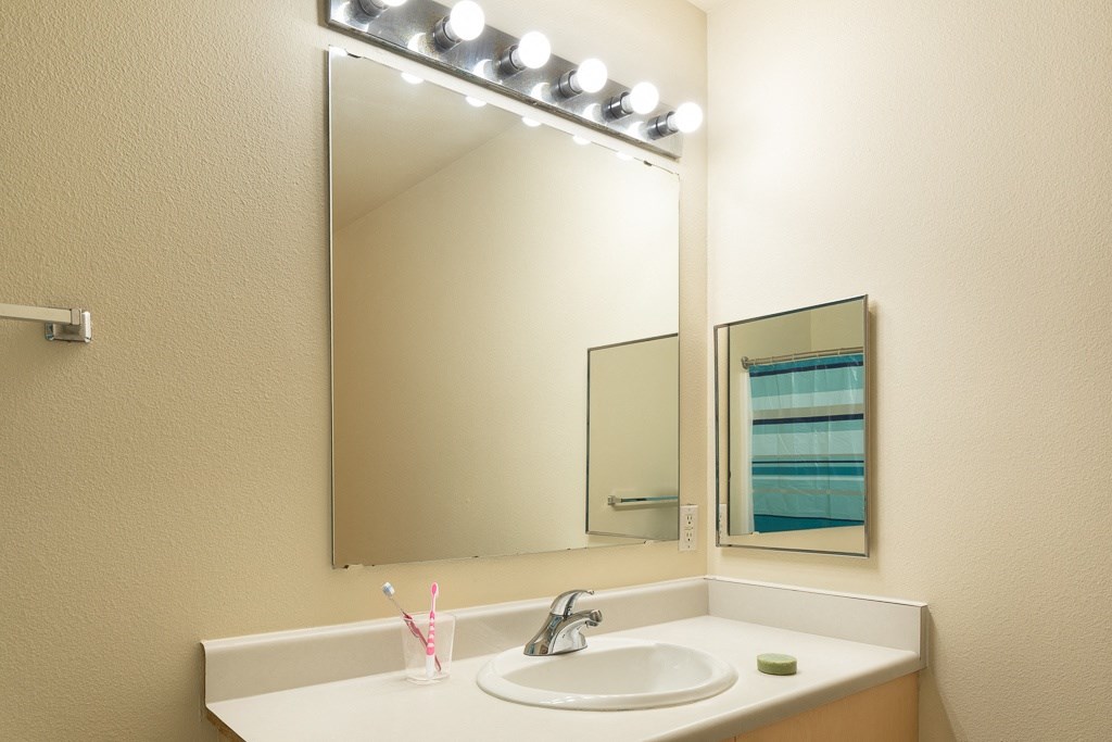 a bathroom with a sink and a mirror