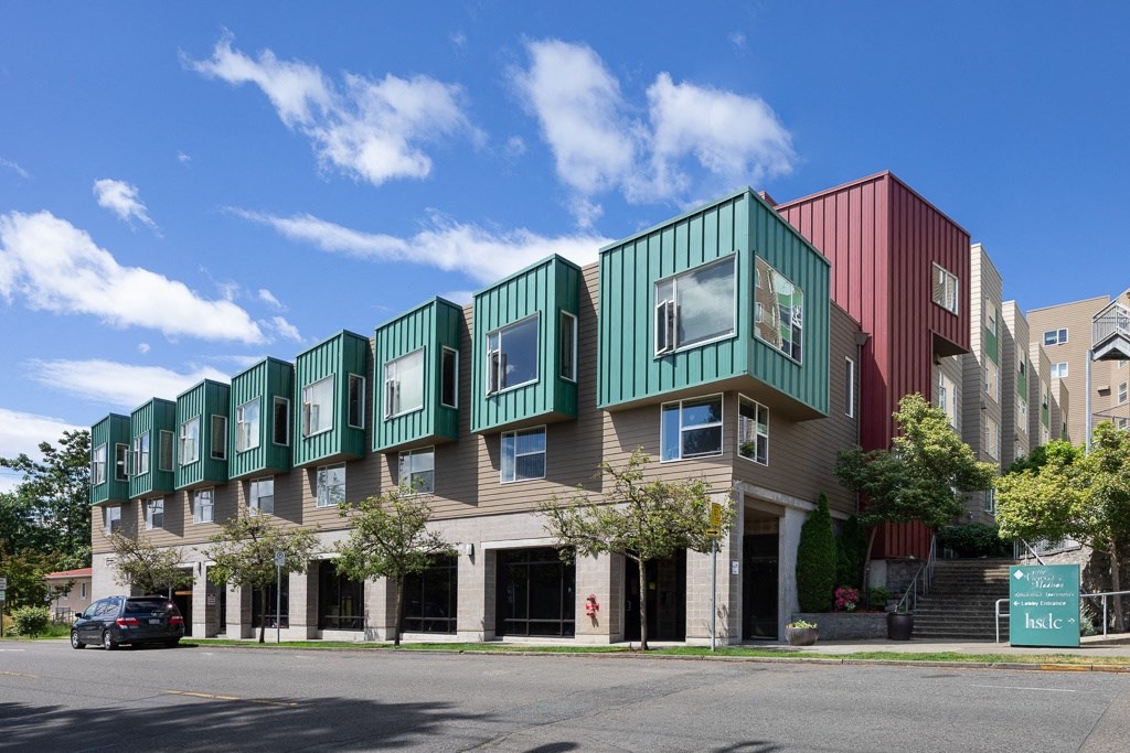 a row of apartment buildings on a city street