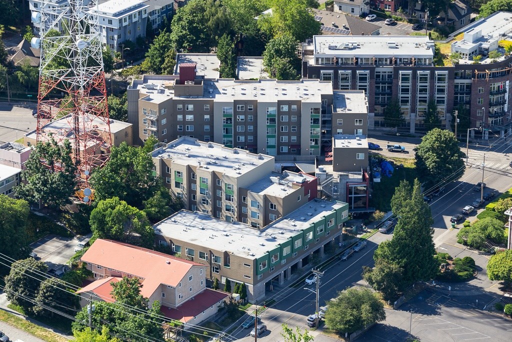 an aerial view of a city with buildings and a tower
