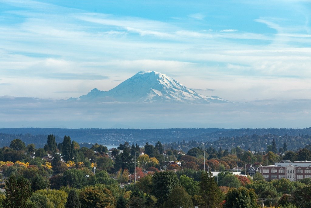 the view of a snow covered mountain over the city