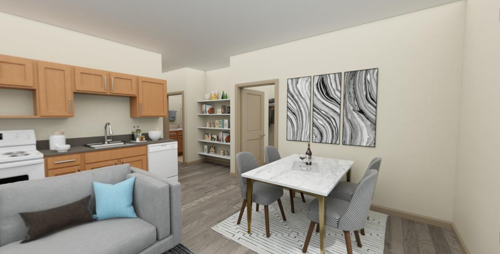 a dining area with a white table and chairs and a kitchen in the background