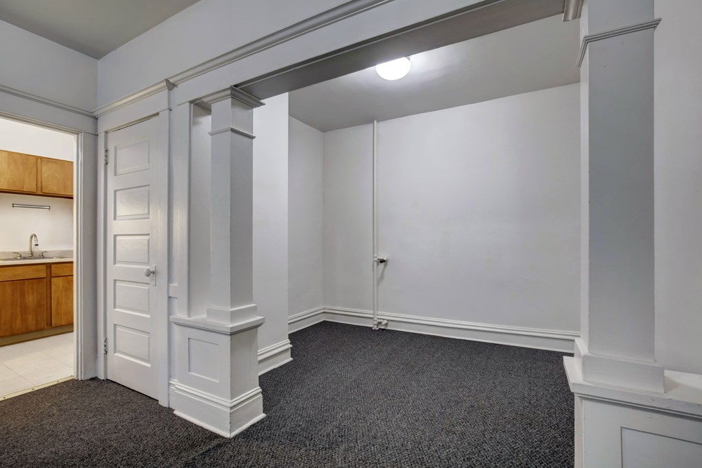 A room with a carpeted floor and white walls.