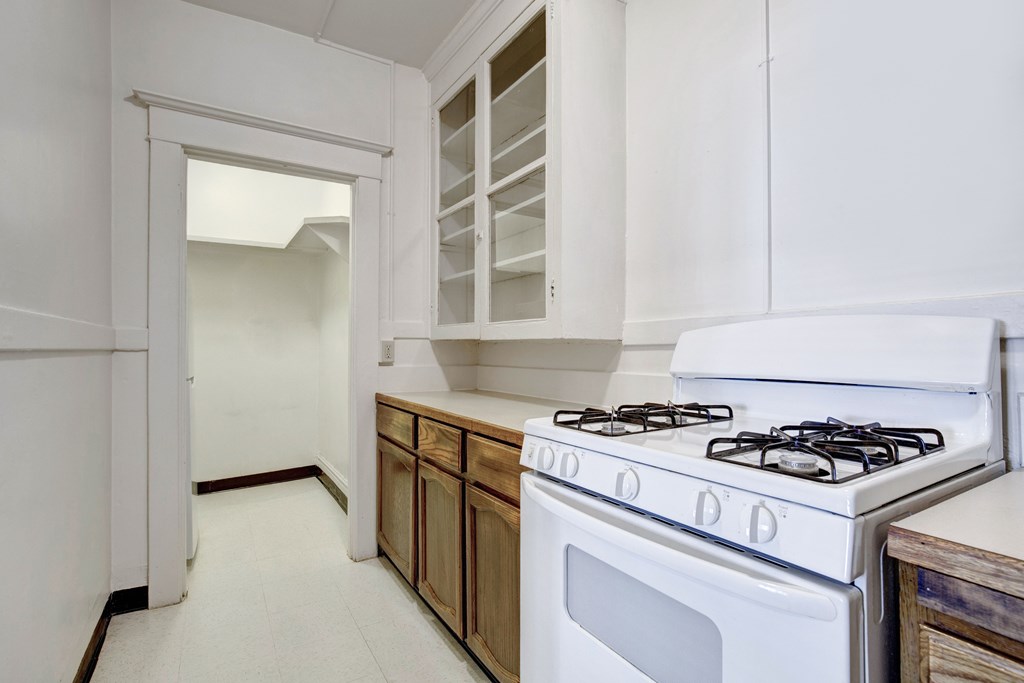 A white stove with a white oven in a kitchen.