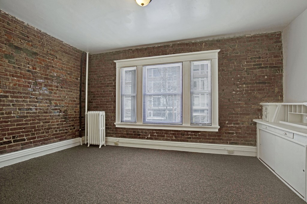 A room with a window and a radiator.