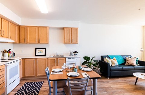 a living room with a kitchen and a dining table
