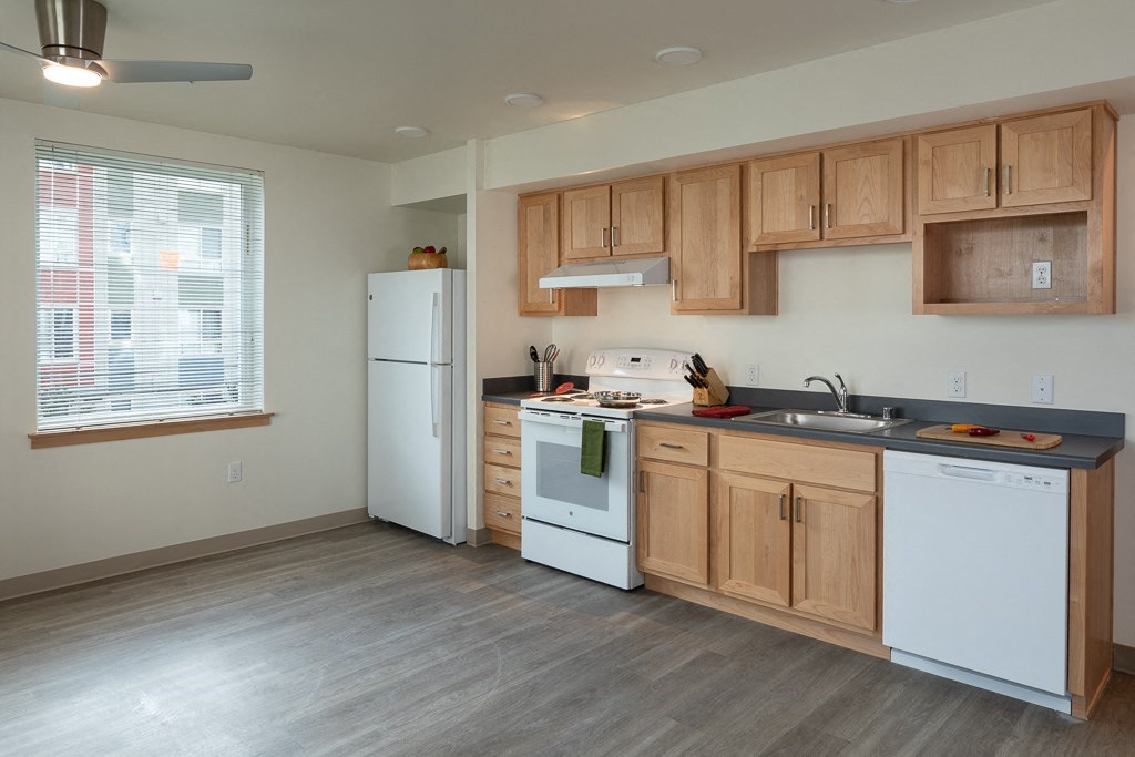 a kitchen with white appliances and wooden cabinets