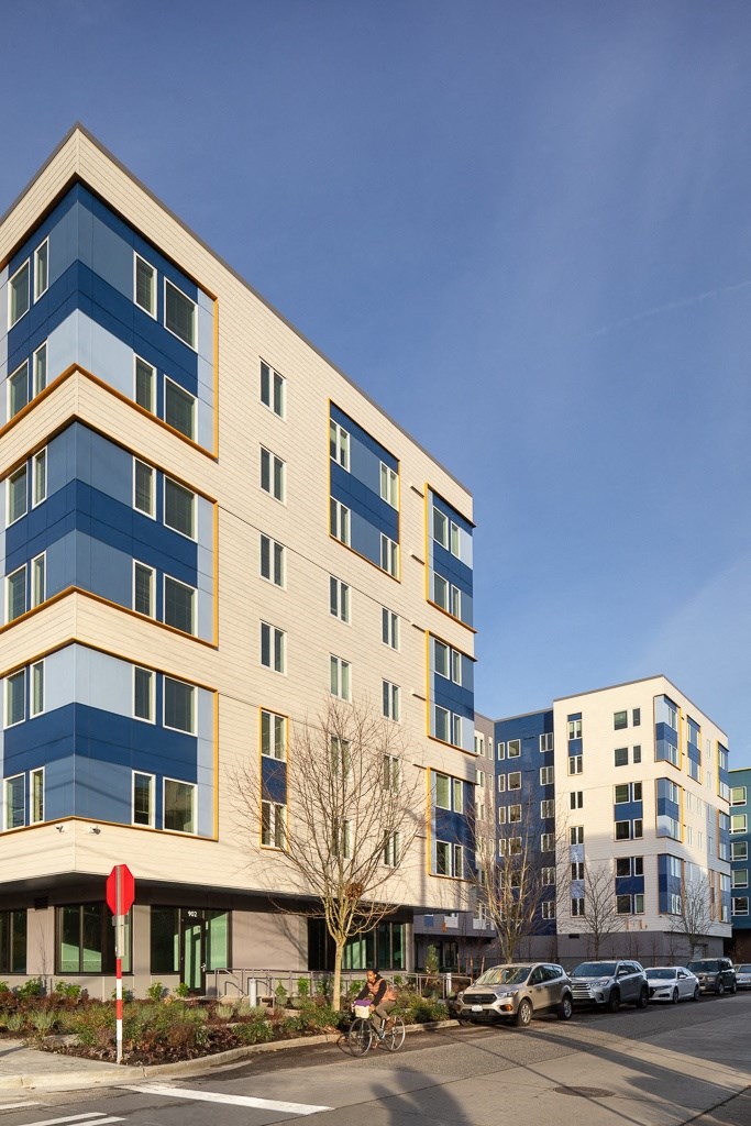 a group of apartment buildings on a city street