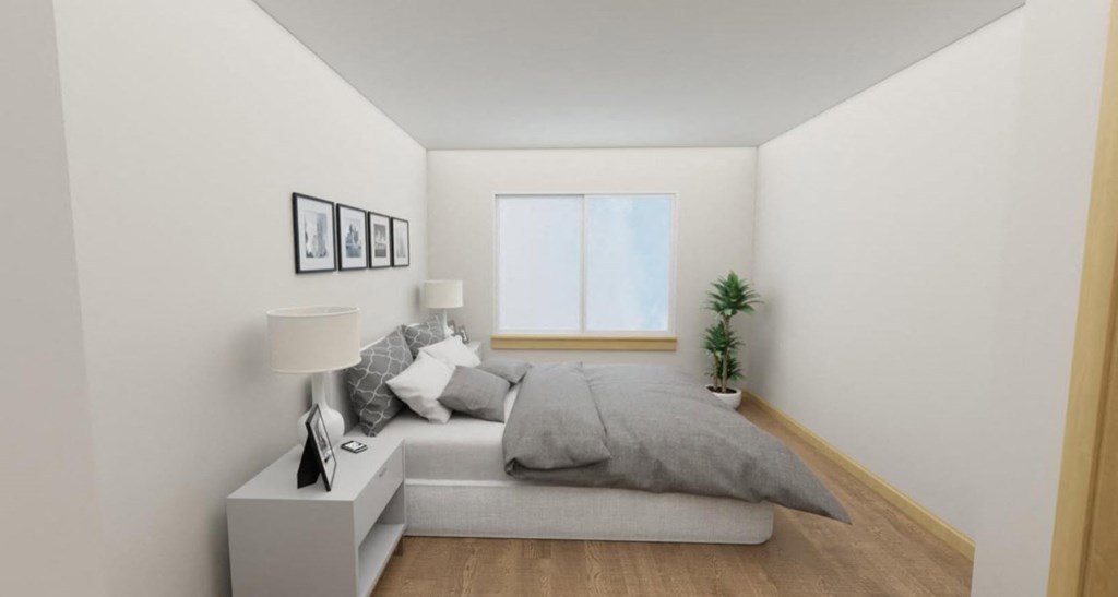 a bedroom with a bed and a window