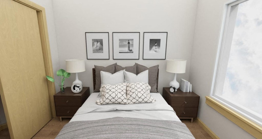 a bedroom with a bed and pictures on the wall