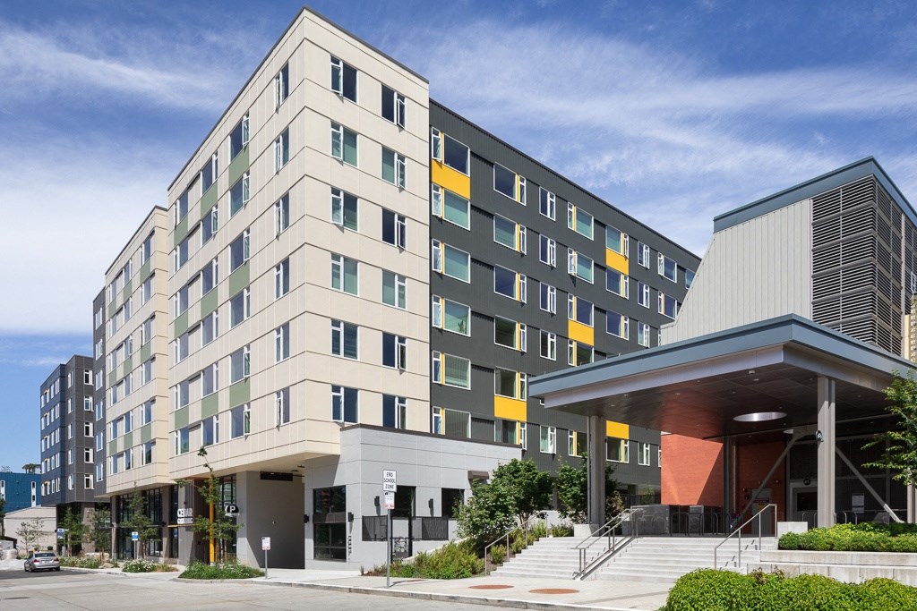 a building with stairs and a street in front of it
