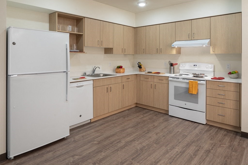 a kitchen with white appliances and wooden cabinets
