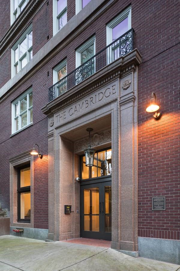 brick building with a balcony and a door at Cambridge Apartments, Seattle