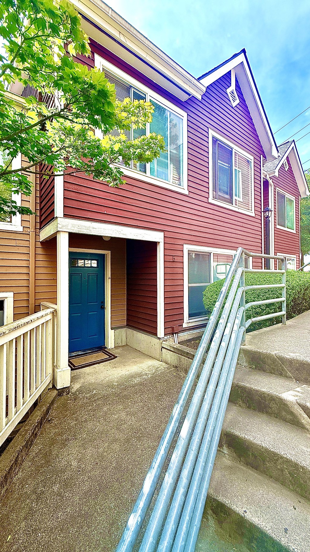 A house with a blue door and a red siding.
