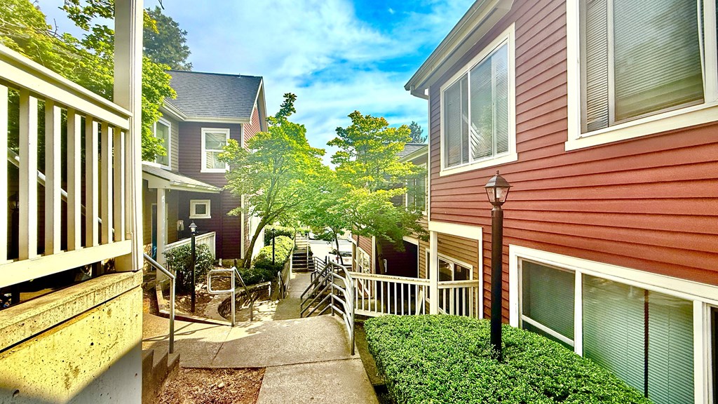 A sunny day in a residential area with houses and greenery.