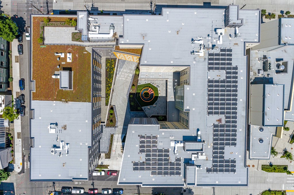 arial view of the roof of a building with solar panels on it