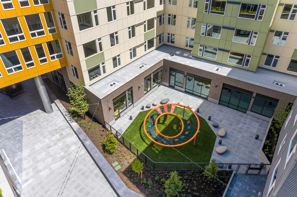 an aerial view of the courtyard of an apartment building with a lawn