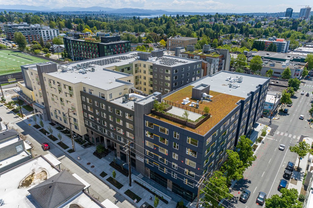 an aerial view of a large building with a green roof