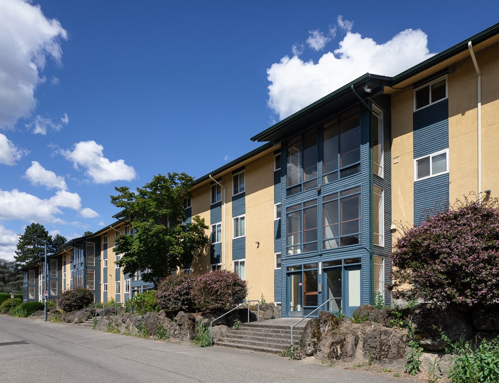 a row of apartment buildings on the side of a street