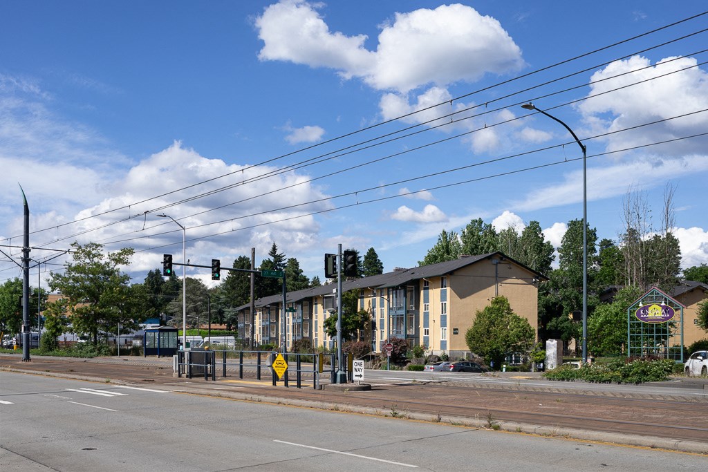 a building at the corner of an intersection with an empty street
