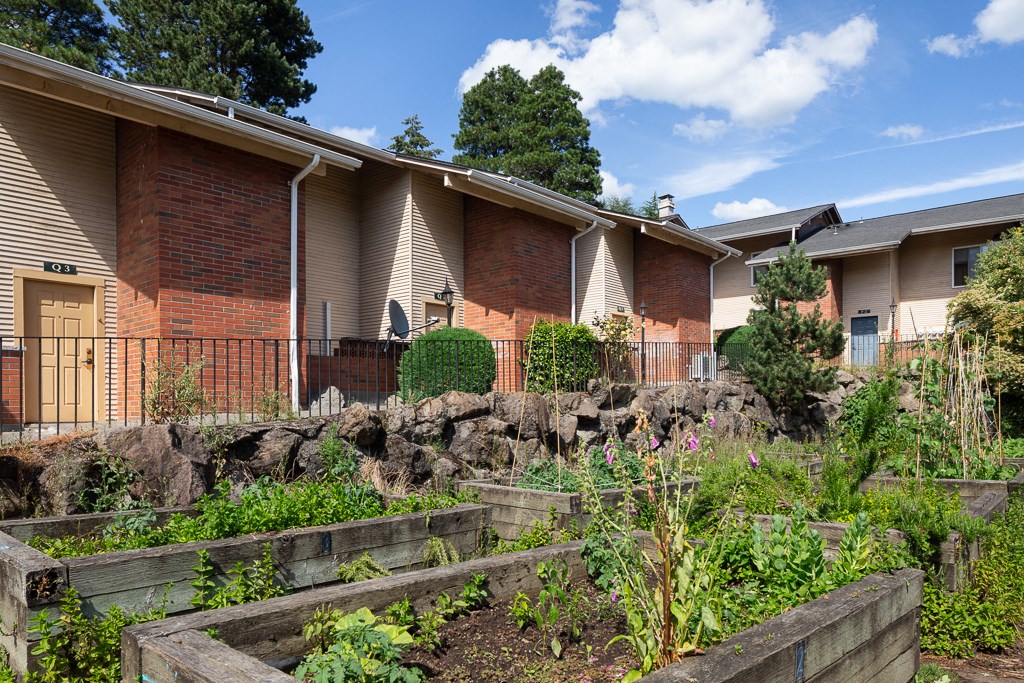 a garden in front of an apartment building
