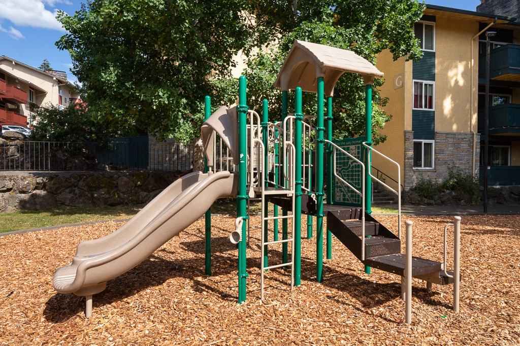 a playground with a slide and a staircase