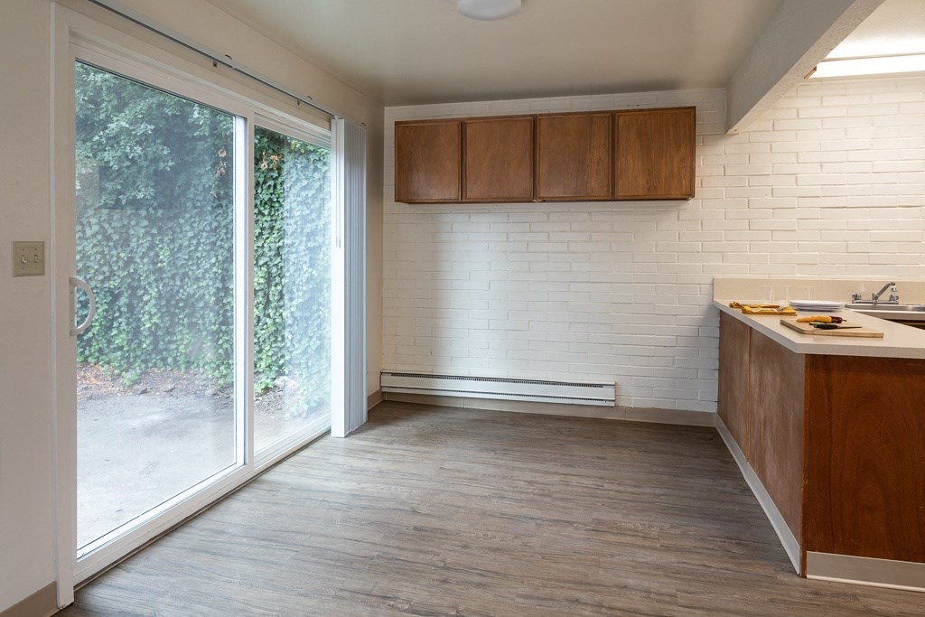 an empty kitchen with a large sliding glass door