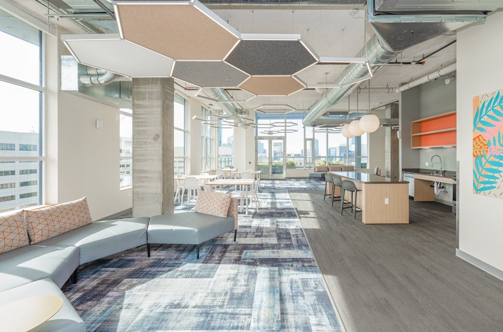 A modern office space with a large open area and a view of the city.