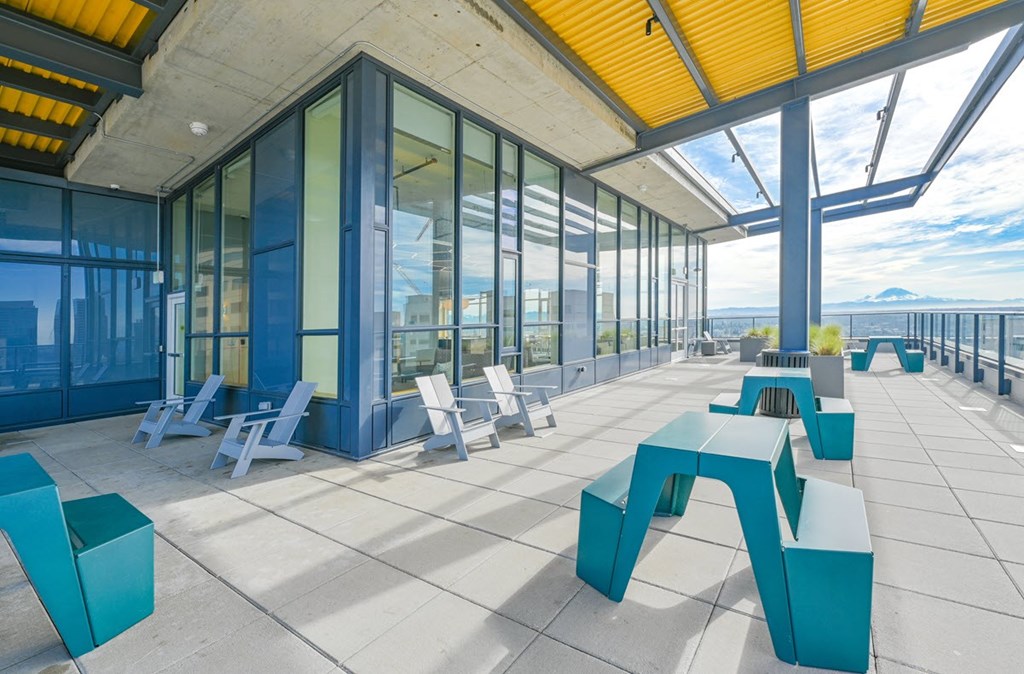 A modern outdoor seating area with blue and white furniture.