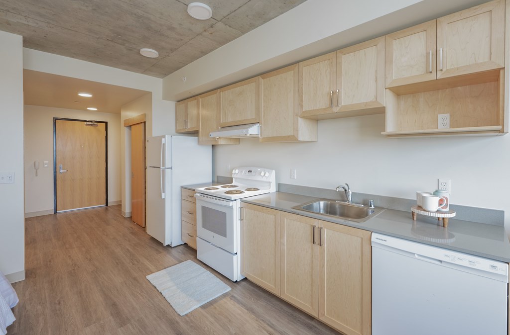 A kitchen with wooden cabinets and white appliances.