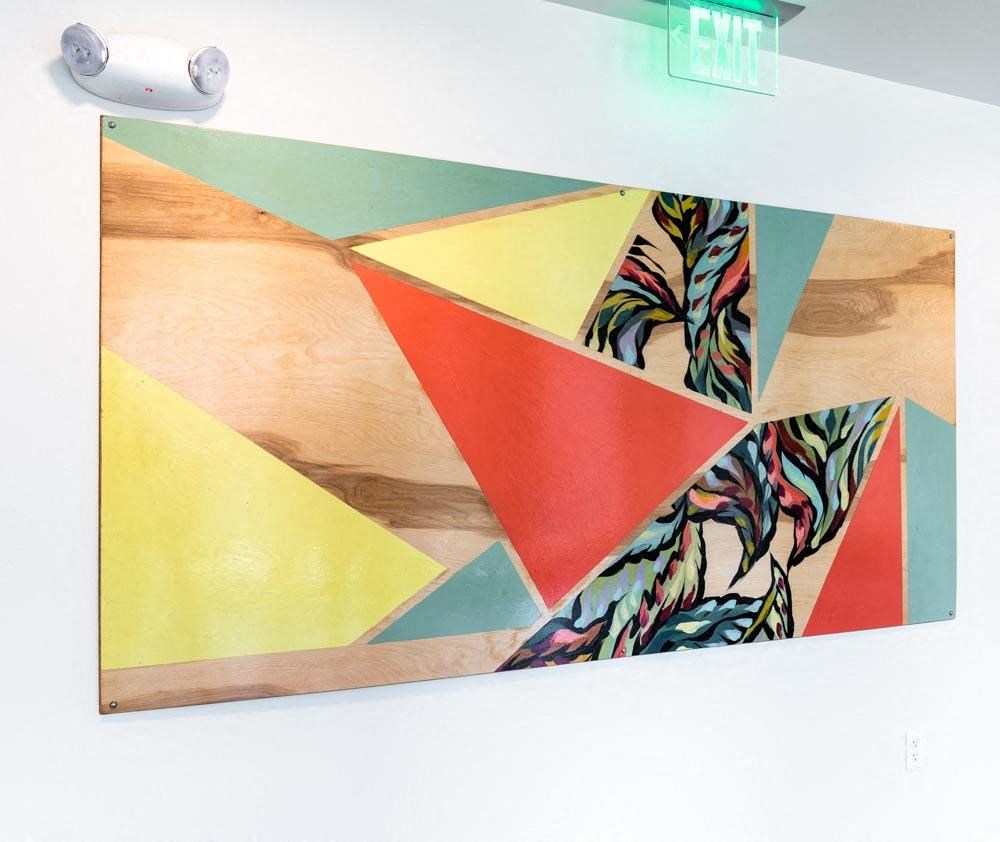 a wall hanging with a geometric painting on it at Arbora Court, Washington, 98105