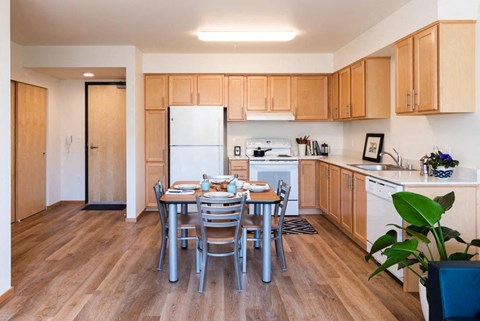a kitchen and dining room with a table and chairs