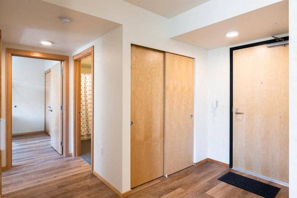 a hallway with two wooden closets at Arbora Court, Seattle, Washington
