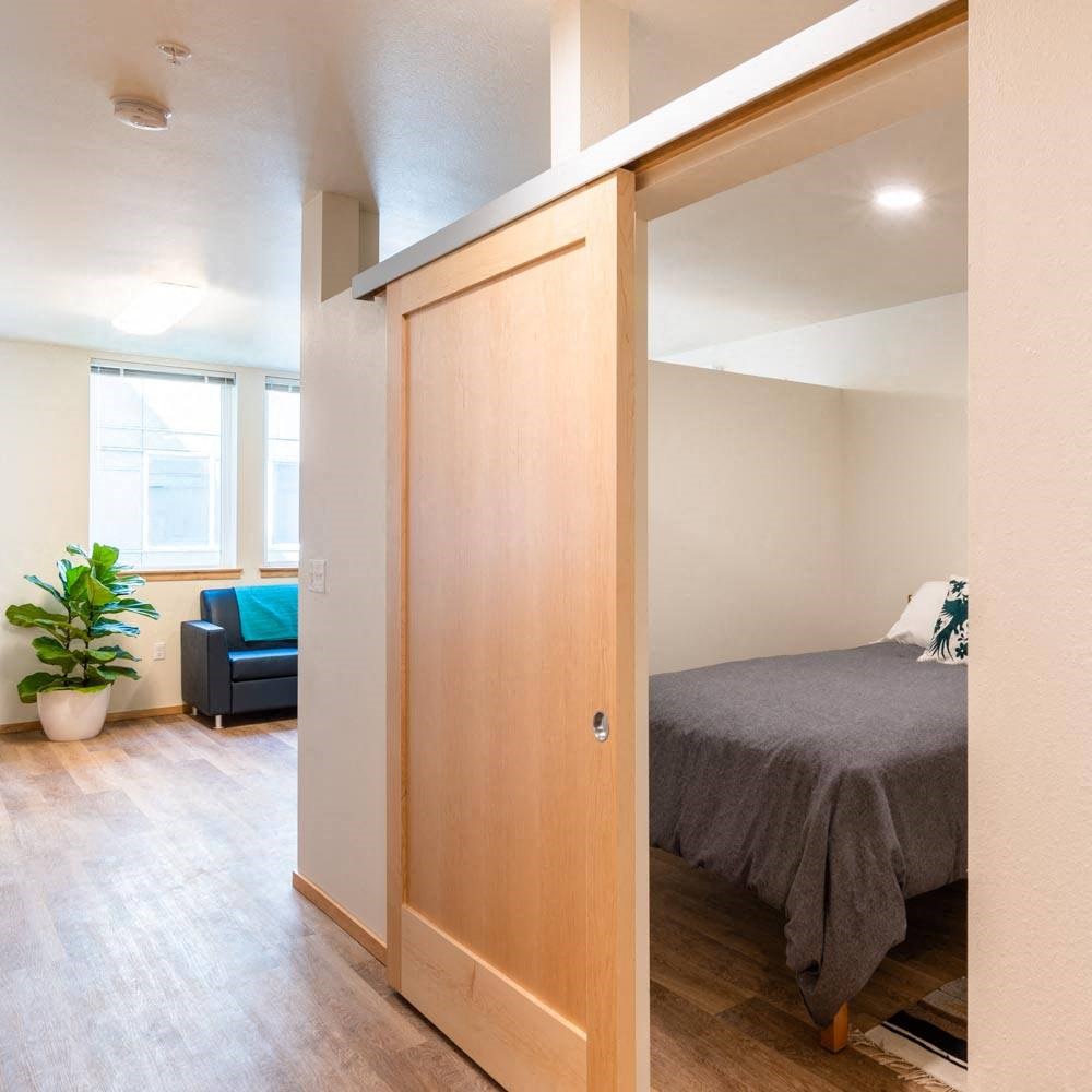 a bedroom with a bed and a closet at Arbora Court, Seattle, WA
