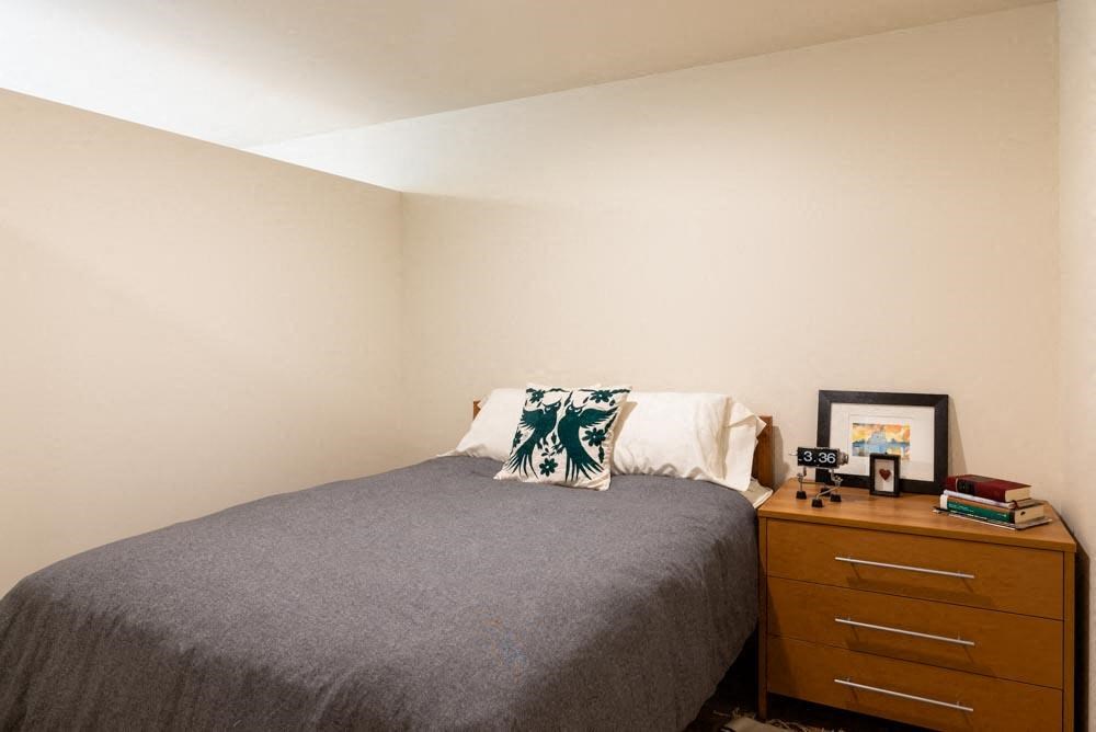a small bedroom with a bed and a dresser at Arbora Court, Washington, 98105