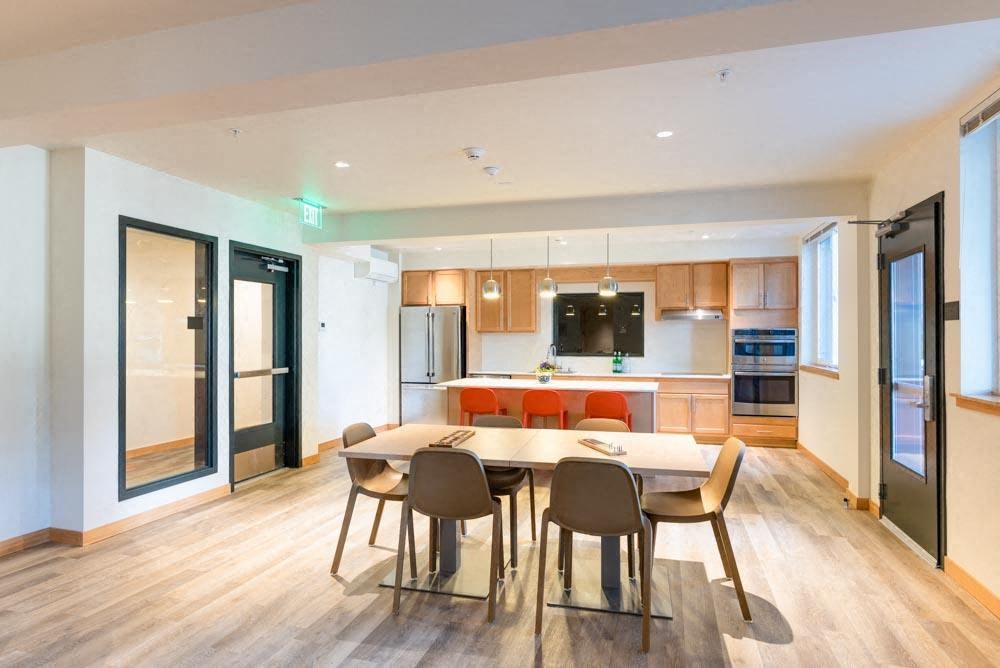 a kitchen and dining room with a table and chairs at Arbora Court, Seattle, 98105