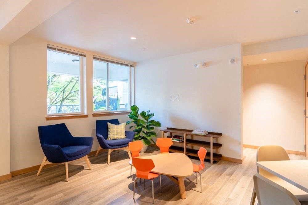 a living room with a table and chairs at Arbora Court, Seattle, Washington