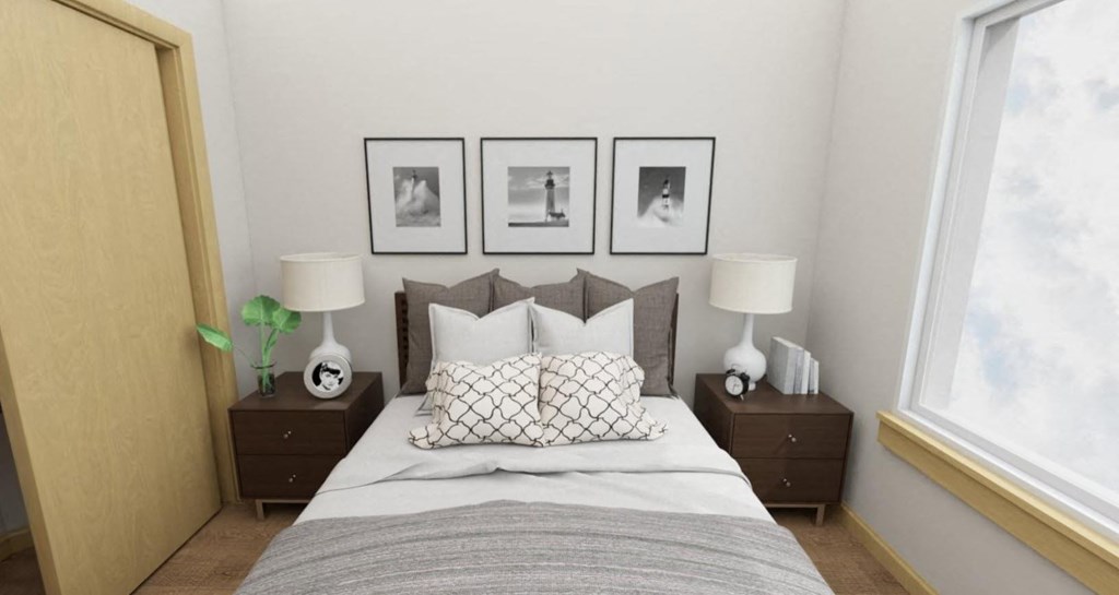 A bedroom with a bed, two lamps, and three pictures on the wall.