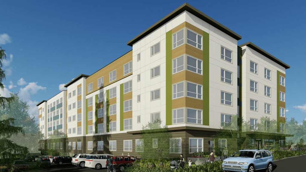 A modern apartment building with cars parked in front.