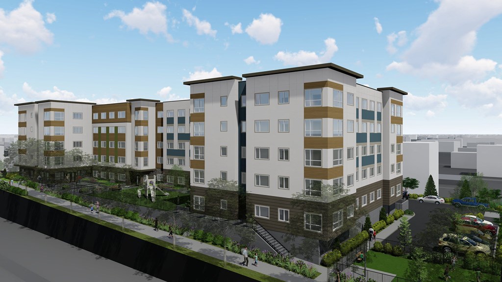 A modern apartment complex with multiple buildings and a parking lot in front.