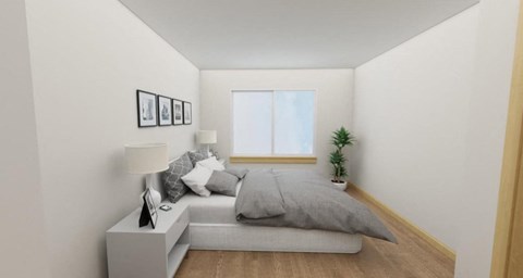 A small bedroom with a bed, nightstand, and a plant.