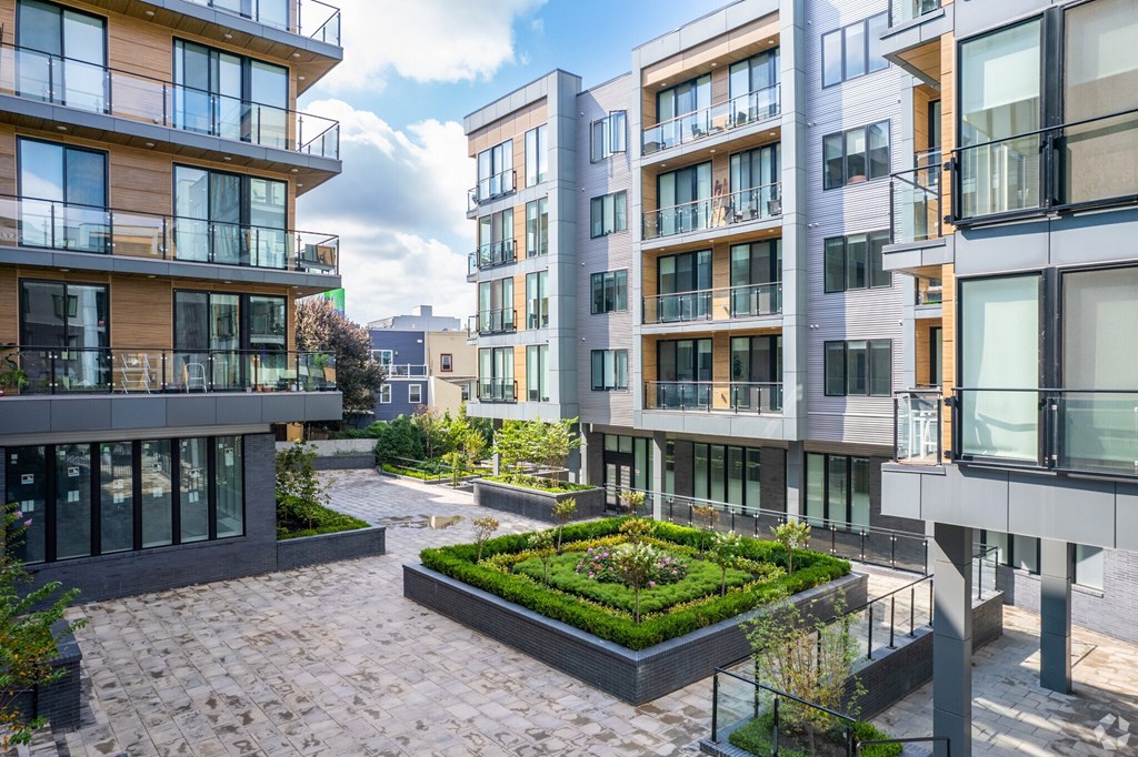 A modern residential area with apartment buildings and a central courtyard.