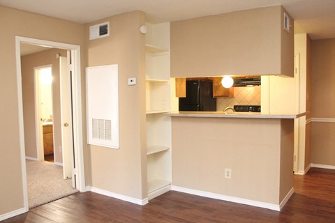 a view of a kitchen and a living room in an empty apartment