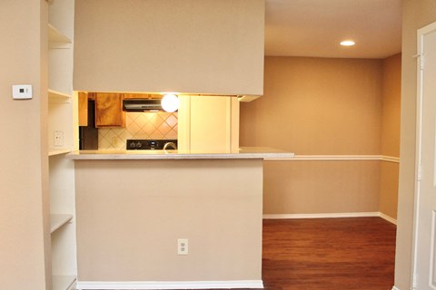 an empty kitchen with a counter and a microwave