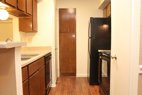 a kitchen with a refrigerator and a sink and a door